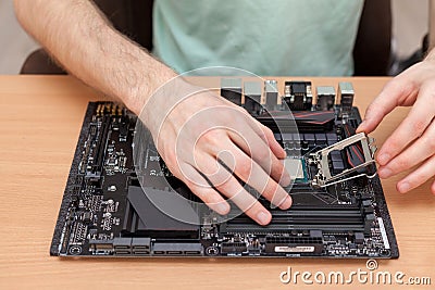 Plug in CPU microprocessor to motherboard socket. Stock Photo