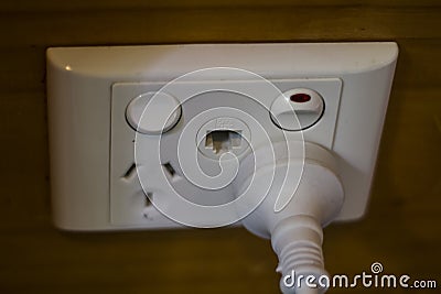 Plug inserted in Electrical socket Stock Photo