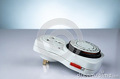 Plug-in timer mechanical 24 hour. Indoor home tools. Plug-in timer socket set isolated on gradient background. Mechanical outlet Stock Photo