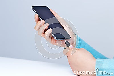 Plugging a charger in a smart phone Stock Photo