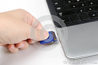 Plugging in SD Card into laptop Stock Photo