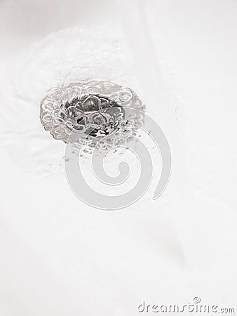 Plughole with water Stock Photo