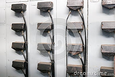 Plugs for wires for connecting iron metal cabinets for electrical equipment of electric motors at an industrial refinery chemical Stock Photo