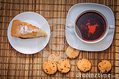 Plum biscuit cake for a cup of hot tea on a straw bedding with c Stock Photo