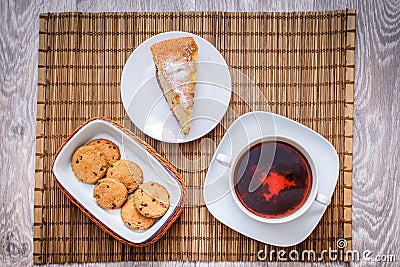 Plum biscuit cake for a cup of hot tea on a straw bedding with c Stock Photo