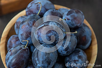Plum variety Hungarian. Fruit harvest on the table in the kitchen. Autumn blue plum. Vitamin food bowl Stock Photo