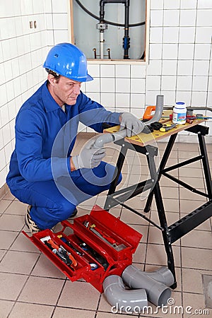 Plumber adjusting pipe Stock Photo