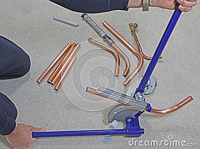 Plumber constructing pipework Stock Photo