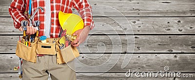 Plumber hands with helmet and water tap. Stock Photo