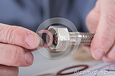 Plumber putting a gasket on a plumbing fitting Stock Photo