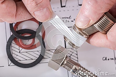 Plumber putting a teflon joint on a thread Stock Photo