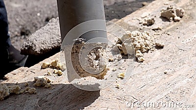 A plumber removes solid deposits from grease and debris. Stock Photo