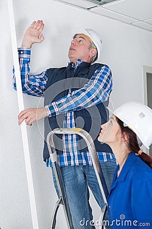 Plumber showing female trainee where to work Stock Photo