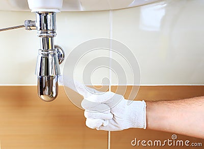 Plumber showing problem area of sink Stock Photo