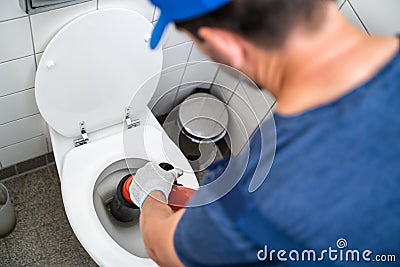 Plumber Toilet Blockage Assistance. WC Cleaning Stock Photo