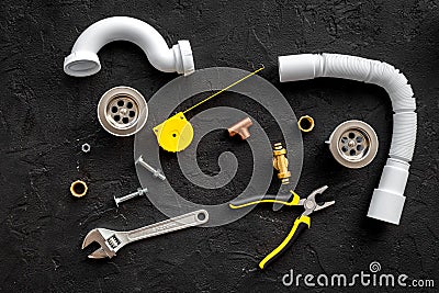 Plumber tools on black background top view Stock Photo