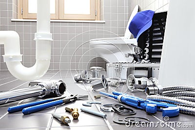 plumber tools and equipment in a bathroom, plumbing repair service, assemble and install concept Stock Photo