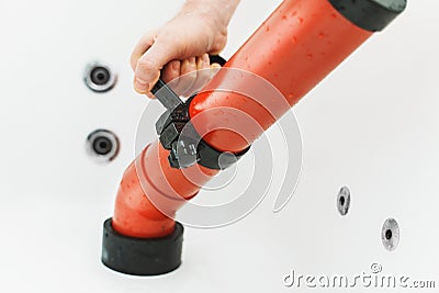 Plumber unclogging bathtub Stock Photo