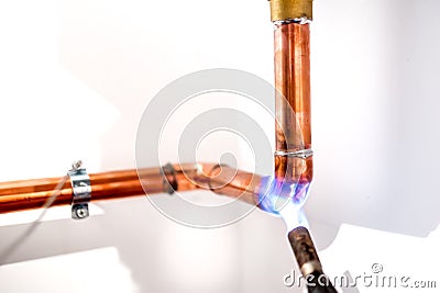 Plumber using blowtorch, propane gas torch for welding copper pipes Stock Photo