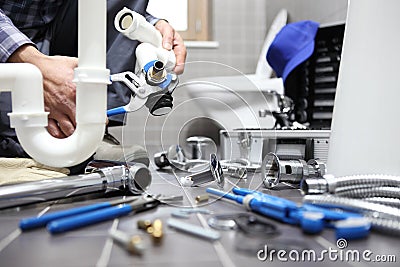 Plumber at work in a bathroom, plumbing repair service, assemble Stock Photo