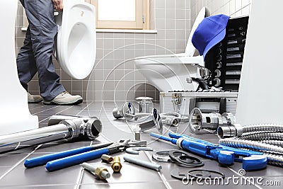 Hands plumber at work in a bathroom, plumbing repair service, as Stock Photo