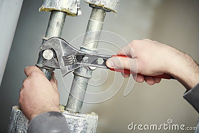 Plumber work. hand with wrench Stock Photo