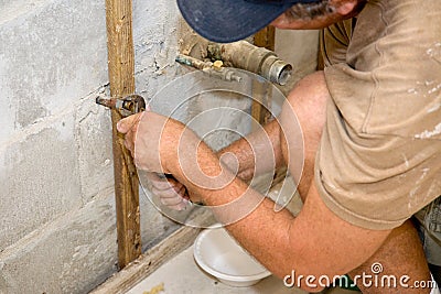 Plumber Working with Pliers Stock Photo