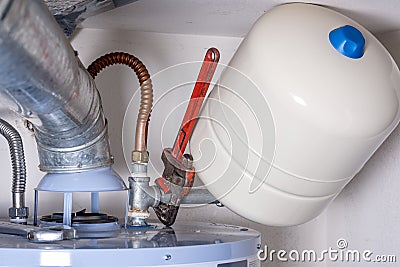 Plumber wrench on a compression tank on a hot water heater Stock Photo