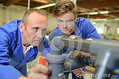 Plumbers checking on tubes Stock Photo