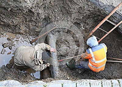 Plumbers repairing water pipe Stock Photo