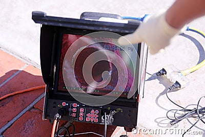 Plumbers sewer snake camera. a snake camera checks the inside of a sewer drain to make sure its clear of blockage and or damage. Stock Photo