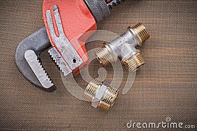 Plumbers wrench brass plumbing fixtures on cleaning mesh filter Stock Photo