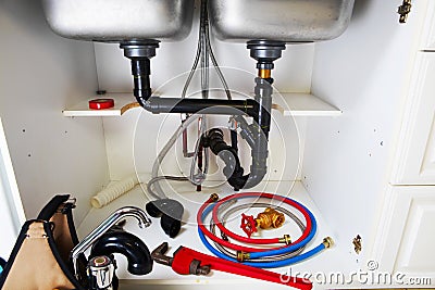 Plumbing tools on the kitchen. Stock Photo