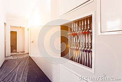 Plumbing white plastic pipes, fittings and ball valves are installed in apartment during construction, remodeling Stock Photo