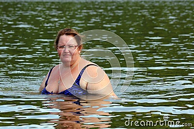 Plump woman bath in river Stock Photo