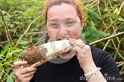 Plump Woman Chewing A Cassava Root Stock Photo