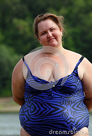 Plump woman standing near river Stock Photo