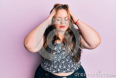 Plus size caucasian young woman wearing casual clothes with hand on head, headache because stress Stock Photo