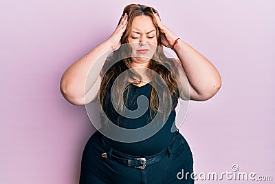 Plus size caucasian young woman wearing casual clothes over pink background with hand on head, headache because stress Stock Photo