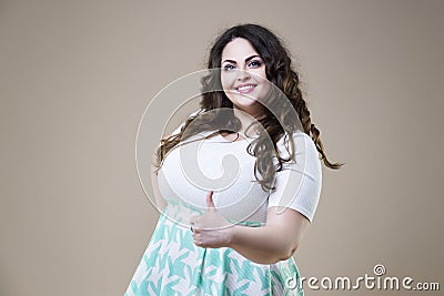 Plus size fashion model in casual clothes, fat woman on studio background, overweight female body Stock Photo