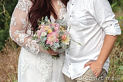 Plus size wedding couple is standing and hugging outside. Curvy Stock Photo