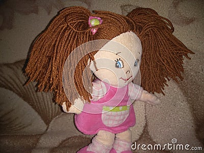 Plush doll in a pink dress Stock Photo