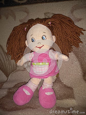 Plush doll in a pink dress Stock Photo