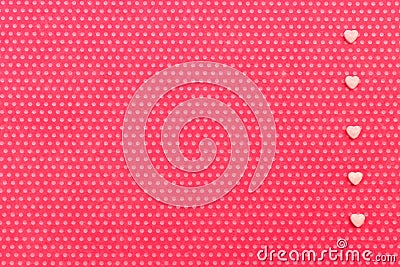 A plush fuchsia background in white polka dots with a with a decorated right field rarely lined upright five hearts Stock Photo