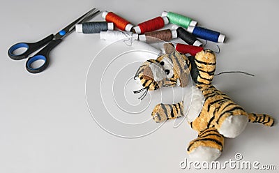 Plush tigger with a torn head. Sewing kit Stock Photo
