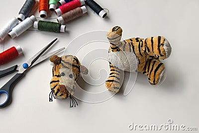 Plush tigger with a torn head. Sewing kit Stock Photo