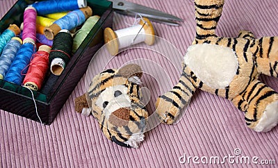 Plush tigger with a torn head. Torn toy Stock Photo