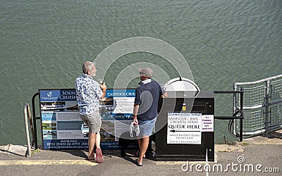 Holidaymakers relax on the waterfront in Plymouth, Devon. Editorial Stock Photo