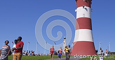 People enjoying the unusually warm weather on Plymouth Hoe, UK Editorial Stock Photo