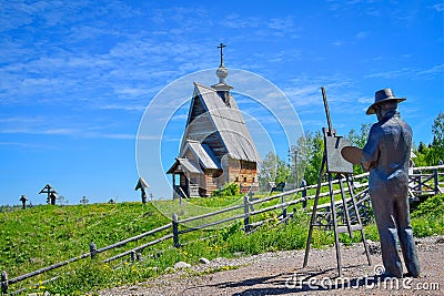 Levitan statue with a wooden church in Plyos Stock Photo